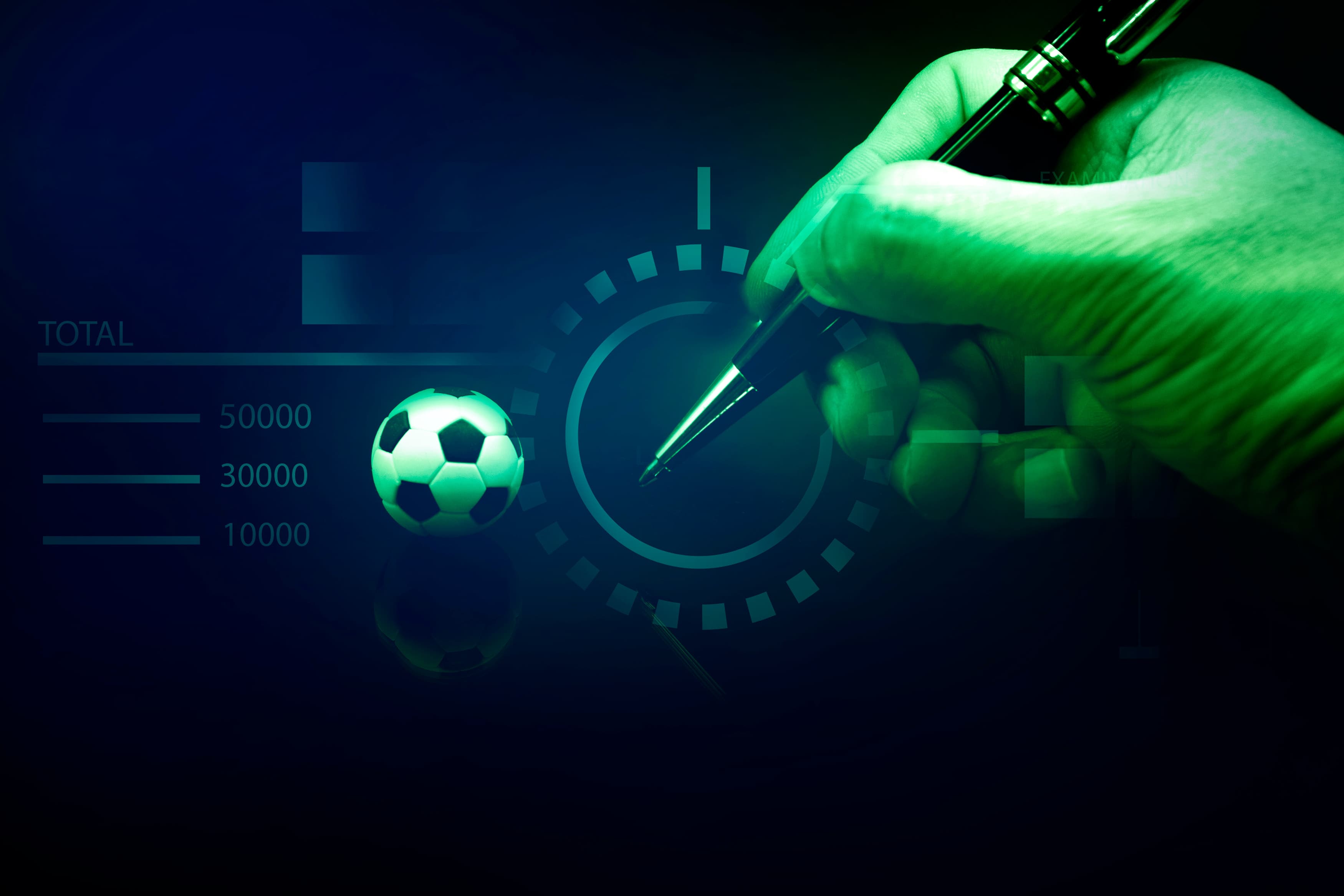 A hand holding a pen against a dashboard of charts and graphs with a football, illustrating data-driven prediction